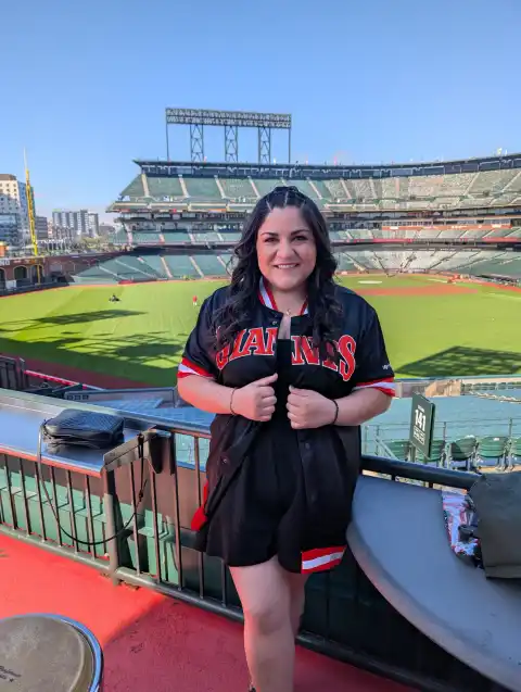 Laura Bravo in a Giants jersey on the stage before the gates open at Oracle Park